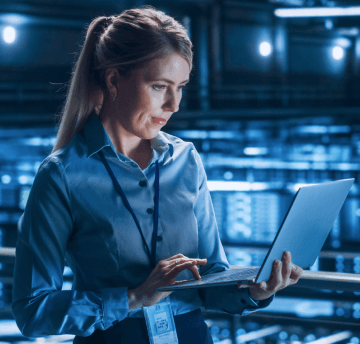 Women working on laptop in factory.